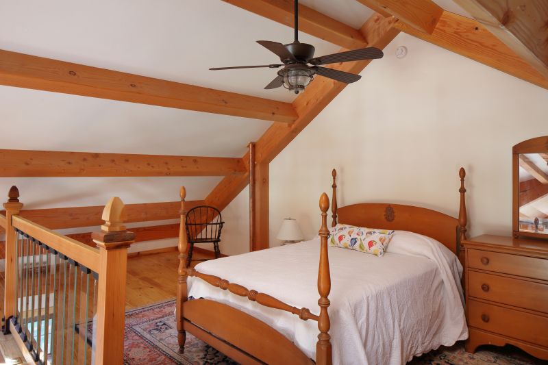 The timber frame creates a cozy loft bedroom