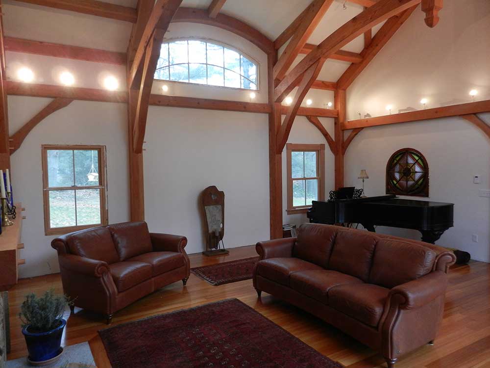 The decor is simple and uncluttered, highlighting the drama of the curved ceiling trusses.