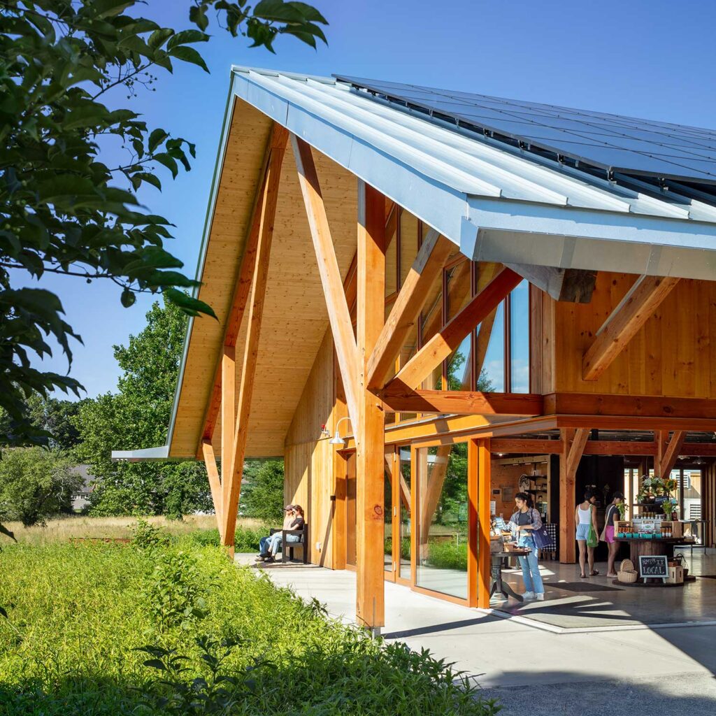exterior of timber post and beam farmstand with solar panels