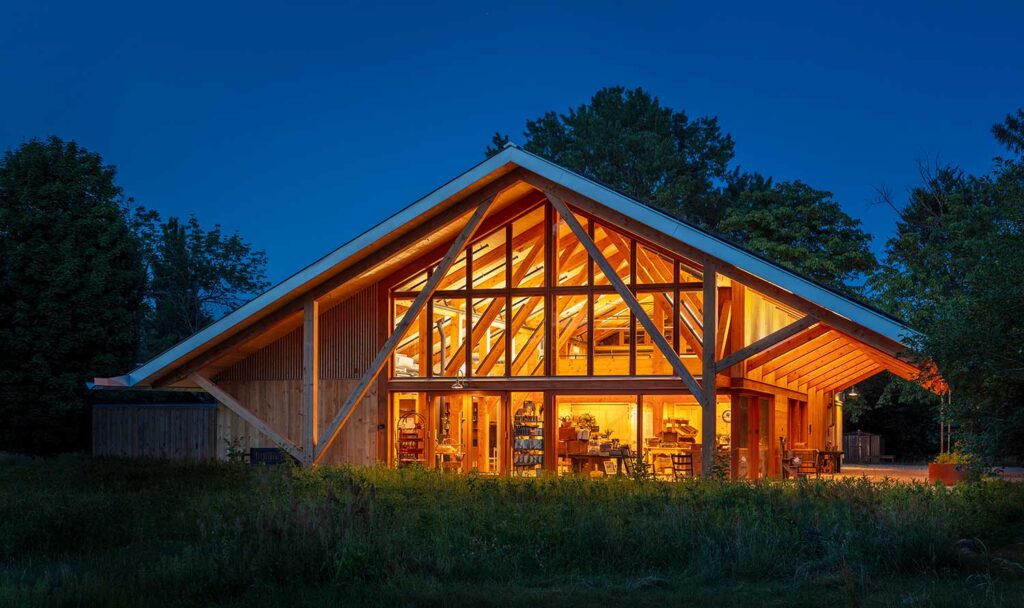 timber post and beam farmstand at night