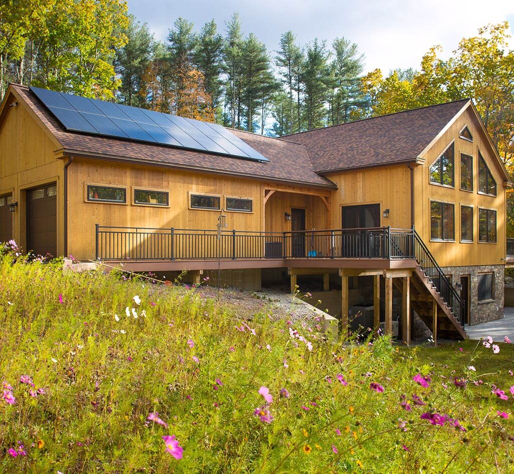timber frame home exterior large windows solar panels