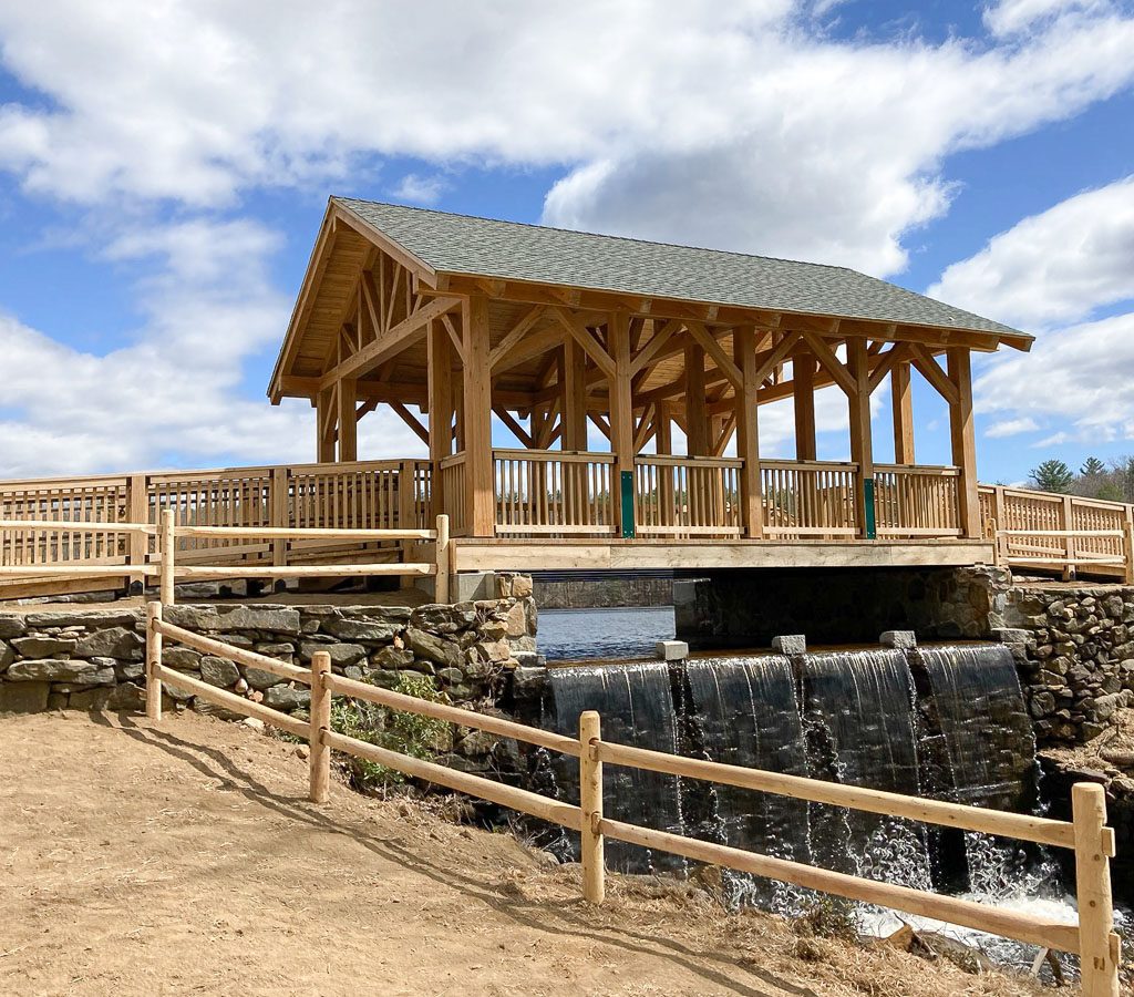 Covered bridge gazebo above waterfall