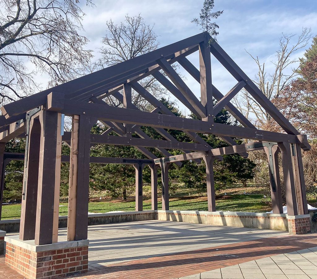 Dark pergola on brick foundation