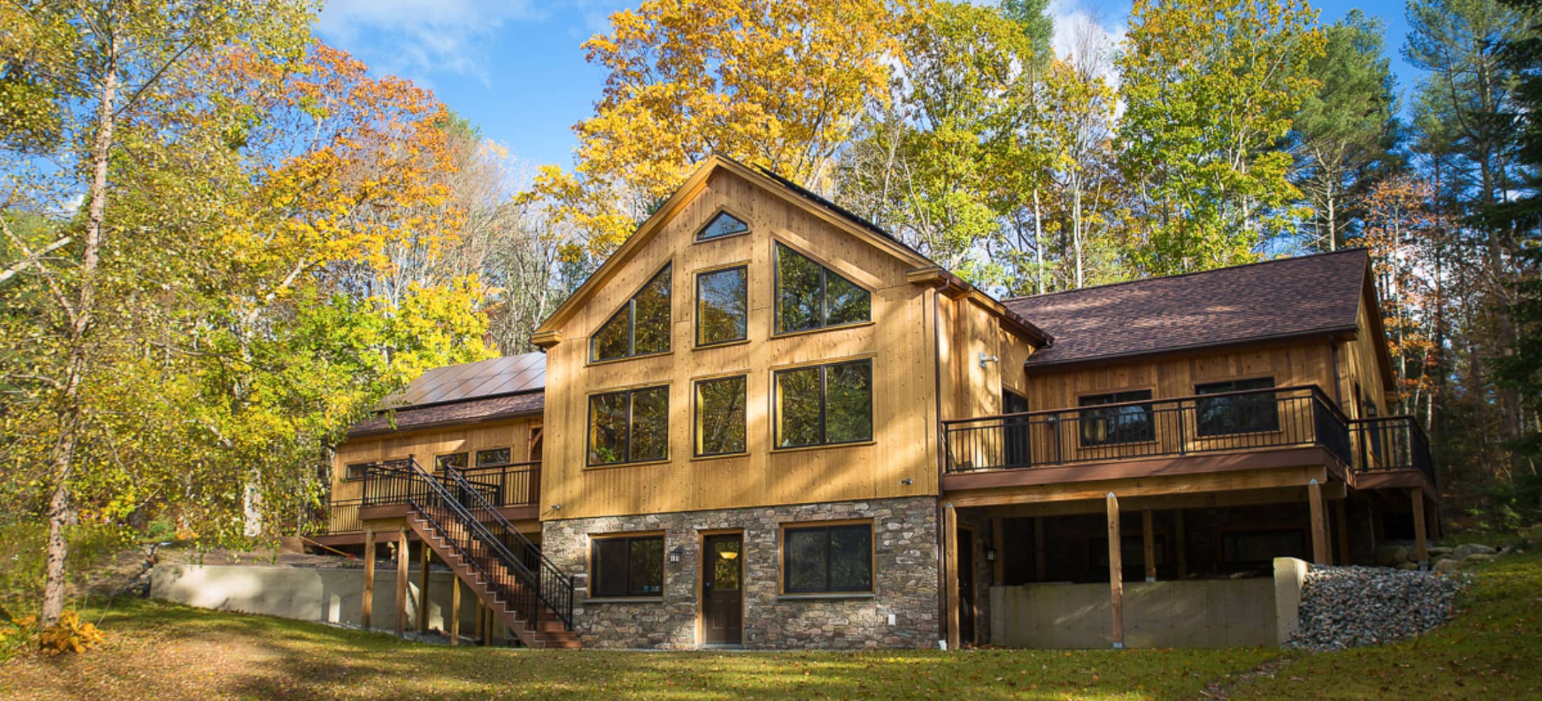 timber frame exterior with large windows and stone facade